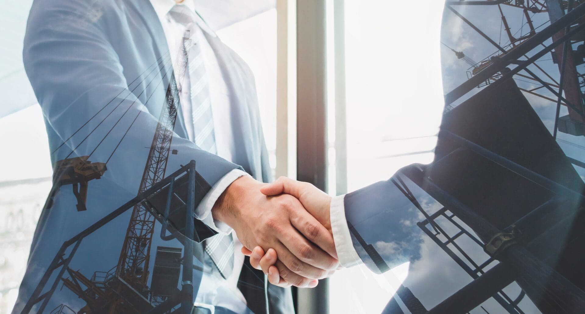 Business handshake with construction overlay