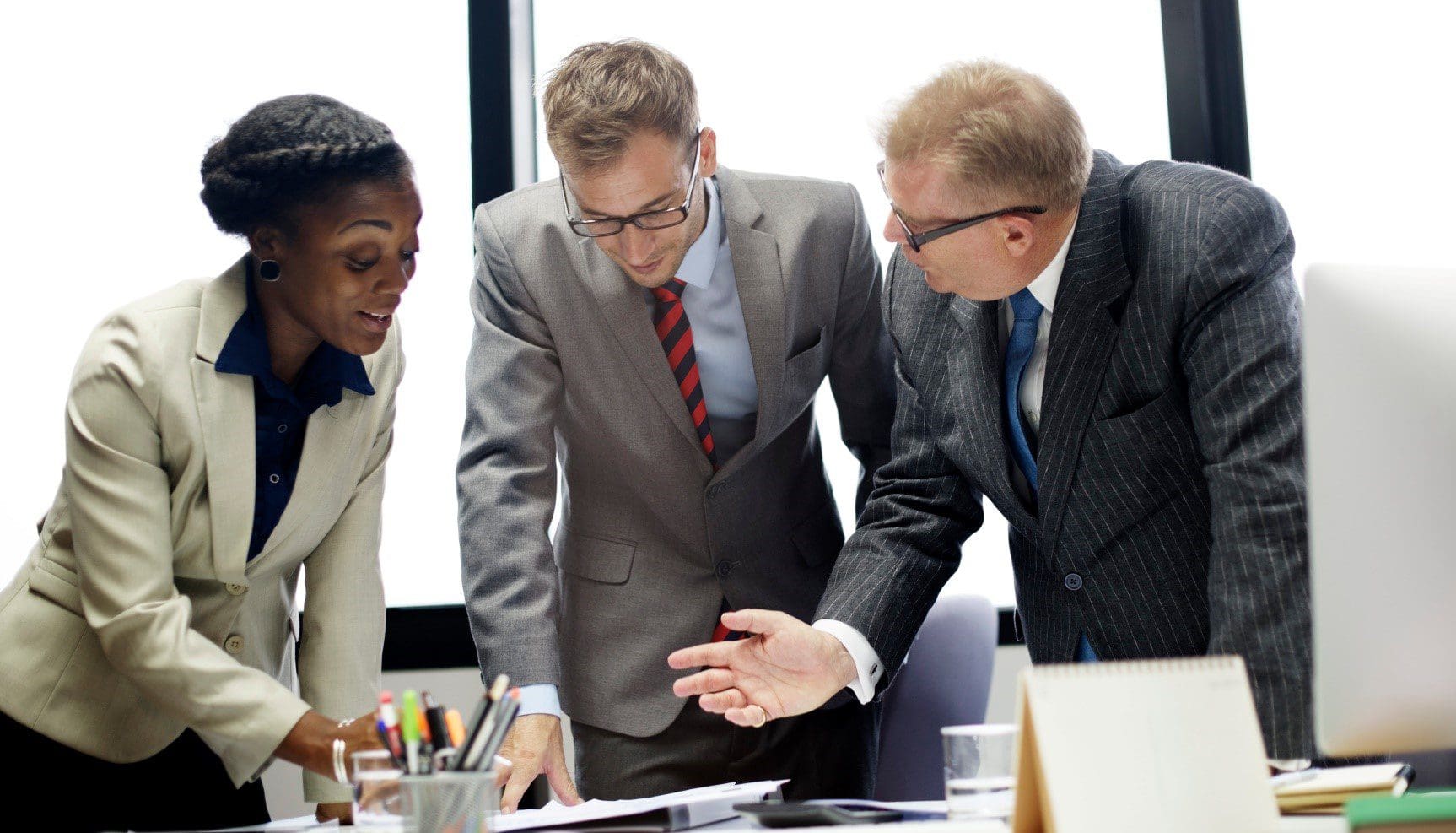 Business team discussing documents at table